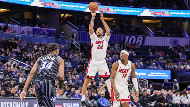 Dec 9, 2025; Orlando, Florida, USA; Miami Heat guard Norman Powell (24) shoots a three point basket during the first quarter against the Orlando Magic at Kia Center. Mandatory Credit: Mike Watters-Imagn Images