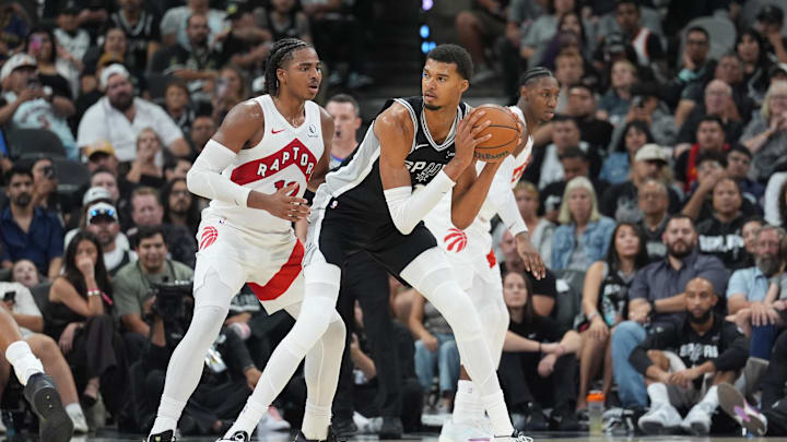 Oct 27, 2025; San Antonio, Texas, USA; San Antonio Spurs forward/center Victor Wembanyama (1) looks to pass in front of Toronto Raptors forward Collin Murray-Boyles (12) in the second half at Frost Bank Center. Mandatory Credit: Daniel Dunn-Imagn Images Oct 27, 2025; San Antonio, Texas, USA; San Antonio Spurs forward/center Victor Wembanyama (1) looks to pass in front of Toronto Raptors forward Collin Murray-Boyles (12) in the second half at Frost Bank Center. Mandatory Credit: Daniel Dunn-Imagn Images