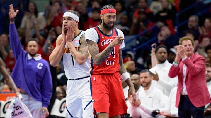 New Orleans Pelicans forward Brandon Ingram (14) celebrates a three-point basket by guard Jaylen Nowell (not pictured) next to Denver Nuggets forward Michael Porter Jr. (1) during the first half at Smoothie King Center. Mandatory Credit: Matthew Hinton-Imagn Images