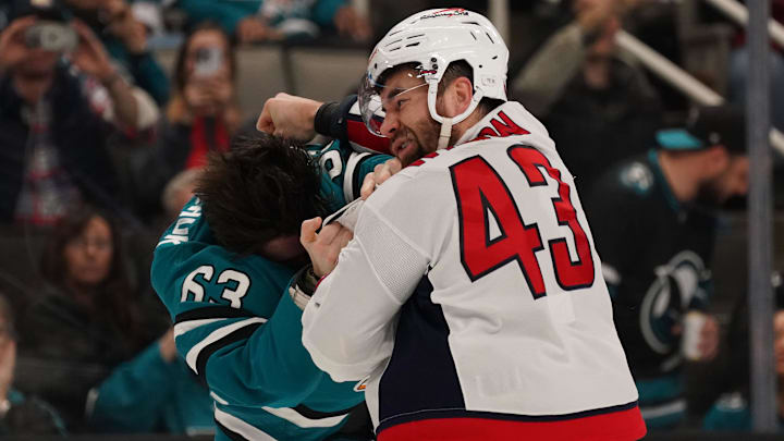 Mar 15, 2025; San Jose, California, USA;  San Jose Sharks center Zack Ostapchuk (63) and Washington Capitals right wing Tom Wilson (43) fight during the second period at SAP Center at San Jose. Mandatory Credit: David Gonzales-Imagn Images