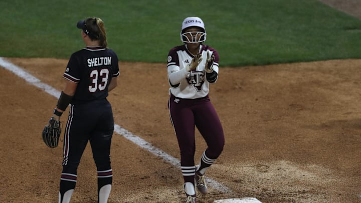 May 8, 2025; Athens, GA, USA; Texas A&M infielder Koko Wooley (3) reacts to her single next to South Carolina infielder Karley Shelton (33) during a game at Jack Turner Stadium. Mandatory Credit: Mady Mertens-Imagn Images