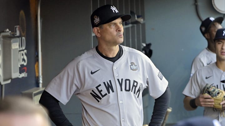 Oct 25, 2024; Los Angeles, California, USA; New York Yankees manager Aaron Boone (17) ooks on from the dugout before game one against the Los Angeles Dodgers in the 2024 MLB World Series at Dodger Stadium. Mandatory Credit: Jayne Kamin-Oncea-Imagn Images Oct 25, 2024; Los Angeles, California, USA; New York Yankees manager Aaron Boone (17) ooks on from the dugout before game one against the Los Angeles Dodgers in the 2024 MLB World Series at Dodger Stadium. Mandatory Credit: Jayne Kamin-Oncea-Imagn Images