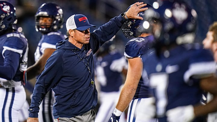 Nov 1, 2024; East Hartford, Connecticut, USA; Connecticut Huskies head coach Jim Mora on the field during warm up before the start of the game against the Georgia State Panthers at Rentschler Field at Pratt & Whitney Stadium. Mandatory Credit: David Butler II-Imagn Images Nov 1, 2024; East Hartford, Connecticut, USA; Connecticut Huskies head coach Jim Mora on the field during warm up before the start of the game against the Georgia State Panthers at Rentschler Field at Pratt & Whitney Stadium. Mandatory Credit: David Butler II-Imagn Images