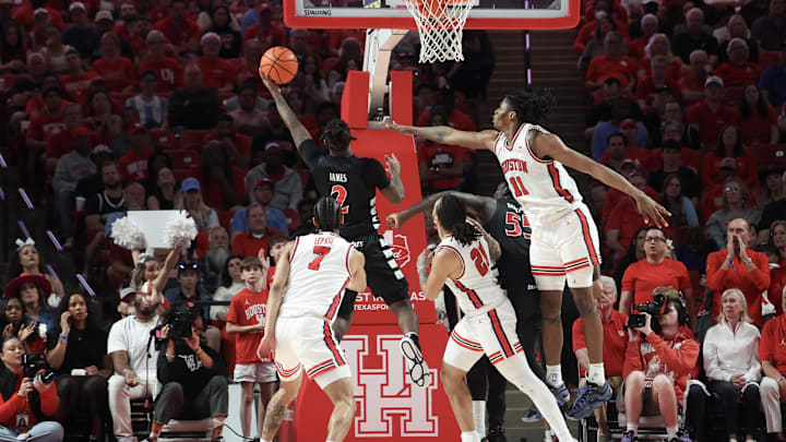 Mar 1, 2025; Houston, Texas, USA; Cincinnati Bearcats guard Jizzle James (2) shoots against Houston Cougars forward Joseph Tugler (11) in the first half at Fertitta Center. Mandatory Credit: Thomas Shea-Imagn Images Mar 1, 2025; Houston, Texas, USA; Cincinnati Bearcats guard Jizzle James (2) shoots against Houston Cougars forward Joseph Tugler (11) in the first half at Fertitta Center. Mandatory Credit: Thomas Shea-Imagn Images