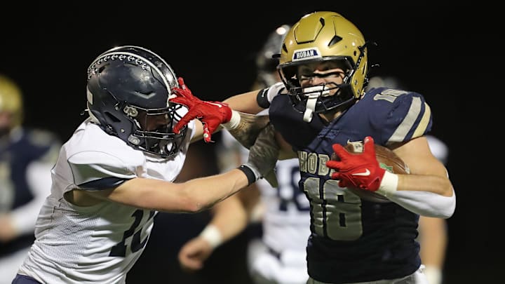 Archbishop Hoban running back runs for a touchdown against Hudson defensive back during the first half of a Division II regional semifinal football game, Nov. 14, 2025, in Akron, Ohio.