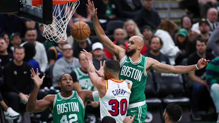 Nov 6, 2024; Boston, Massachusetts, USA; Golden State Warriors guard Stephen Curry (30) passes the ball defended by Boston Celtics guard Derrick White (9) during the first half at TD Garden. Mandatory Credit: Paul Rutherford-Imagn Images