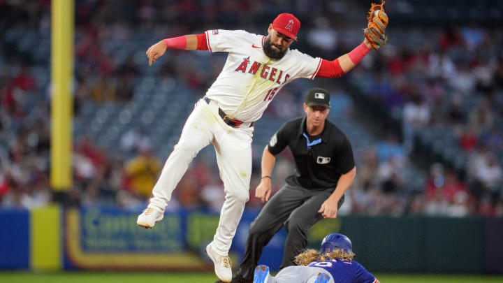 July 8, 2024; Anaheim, California, USA; Texas Rangers designated hitter Travis Jankowski (16) slides into second base to beat a throw to Los Angeles Angels shortstop Luis Guillorme (15) for a stolen base in the sixth inning at Angel Stadium. July 8, 2024; Anaheim, California, USA; Texas Rangers designated hitter Travis Jankowski (16) slides into second base to beat a throw to Los Angeles Angels shortstop Luis Guillorme (15) for a stolen base in the sixth inning at Angel Stadium.