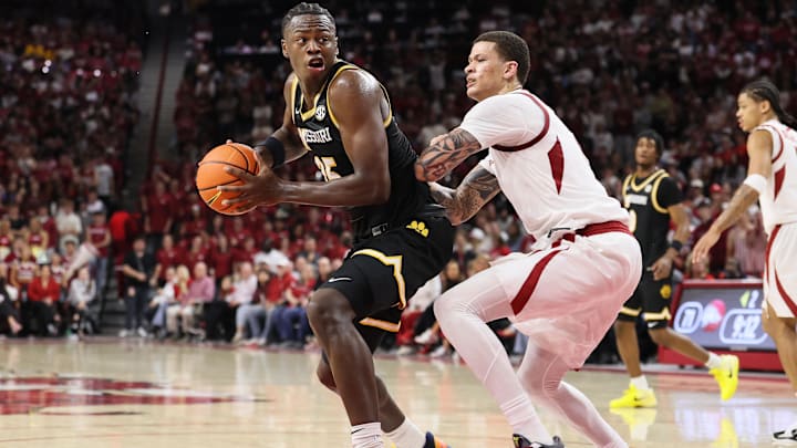 Feb 21, 2026; Fayetteville, Arkansas, USA; Missouri Tigers guard Mark Mitchell (25) drives against Arkansas Razorbacks forward Trevon Brazile (7) during the second half at Bud Walton Arena. Arkansas won 94-86. 