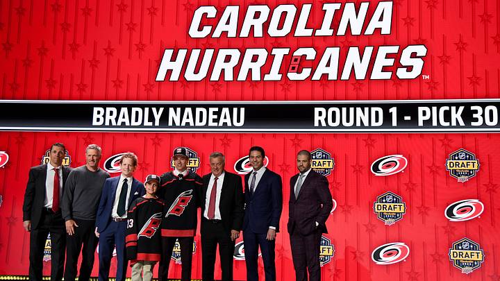 Jun 28, 2023; Nashville, Tennessee, USA; Carolina Hurricanes draft pick Bradly Nadeau stands with Hurricanes staff after being selected with the thirtieth pick in round one of the 2023 NHL Draft at Bridgestone Arena. Mandatory Credit: Christopher Hanewinckel-Imagn Images
