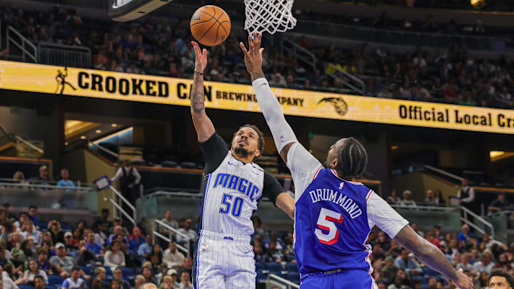 Oct 18, 2024; Orlando, Florida, USA; Orlando Magic guard Cole Anthony (50) goes to the basket against Philadelphia 76ers center Andre Drummond (5) during the second half at Kia Center. Mandatory Credit: Mike Watters-Imagn Images