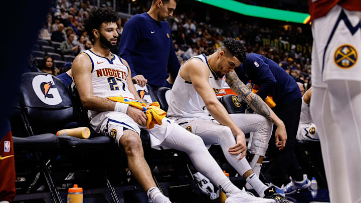 Denver Nuggets guard Jamal Murray (27) and forward Michael Porter Jr. on the bench in the fourth quarter against the Cleveland Cavaliers at Ball Arena in Denver on Dec. 27, 2024.