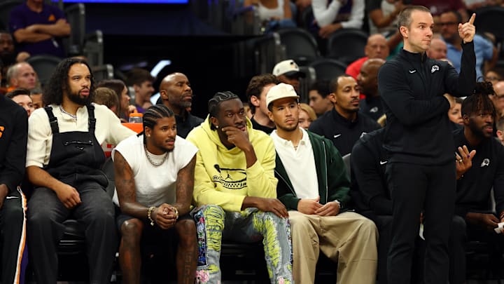 Oct 14, 2025; Phoenix, Arizona, USA; Phoenix Suns players (from left) Dillon Brooks, Jalen Green, Mark Williams, Devin Booker and head coach Jordan Ott against the Los Angeles Lakers during an NBA preseason game at Mortgage Matchup Center. Mandatory Credit: Mark J. Rebilas-Imagn Images