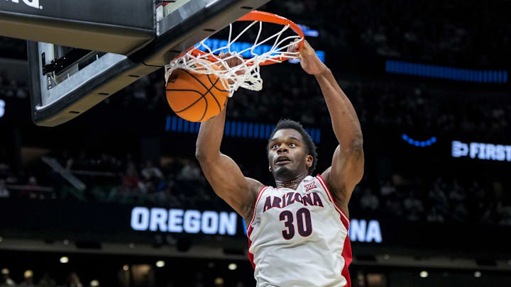 Mar 23, 2025; Seattle, WA, USA;  Arizona Wildcats forward Tobe Awaka (30) dunks the ball against the Oregon Ducks in the first half at Climate Pledge Arena. Mandatory Credit: Stephen Brashear-Imagn Images
