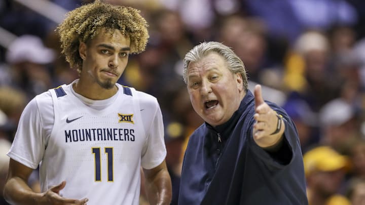 Jan 20, 2020; Morgantown, West Virginia, USA; West Virginia Mountaineers head coach Bob Huggins talks with West Virginia Mountaineers forward Emmitt Matthews Jr. (11) during the second half at WVU Coliseum. Mandatory Credit: Ben Queen-Imagn Images