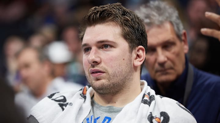 Mar 19, 2022; Charlotte, North Carolina, USA; Dallas Mavericks guard Luka Doncic (77) watches from the bench during the fourth quarter against the Charlotte Hornets at Spectrum Center. Mandatory Credit: Brian Westerholt-Imagn Images