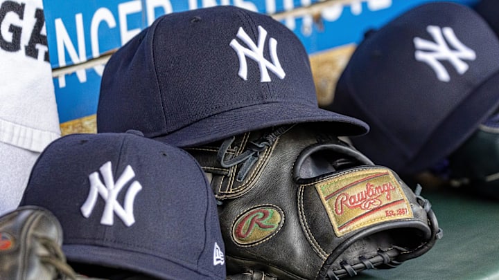 Apr 7, 2025; Detroit, Michigan, USA; New York Yankees baseball hats and gloves in the dugout out in the eighth inning against the Detroit Tigers at Comerica Park. Mandatory Credit: David Reginek-Imagn Images