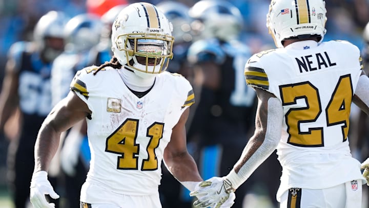 Nov 9, 2025; Charlotte, North Carolina, USA; New Orleans Saints running back Alvin Kamara (41) high fives New Orleans Saints running back Devin Neal (24) during the second quarter against the Carolina Panthers at Bank of America Stadium. Mandatory Credit: Jim Dedmon-Imagn Images