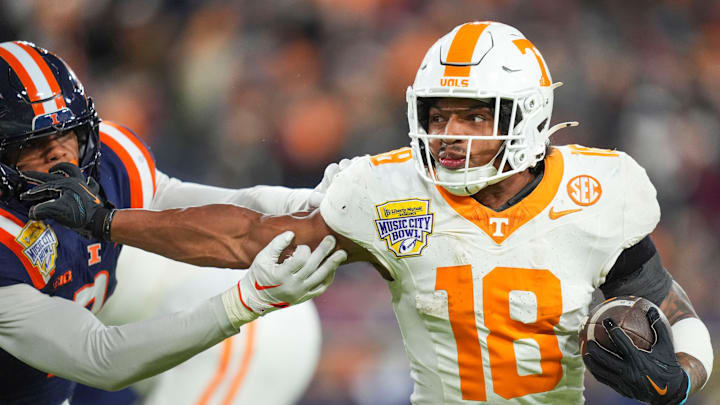 Tennessee running back DeSean Bishop (18) pushes against an Illinois player during the 2025 Music City Bowl at Nissan Stadium in Nashville, Tenn., on Dec. 30, 2025.