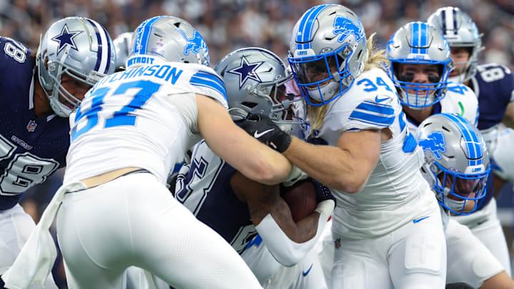 Detroit Lions linebacker Alex Anzalone (34) and Detroit Lions defensive end Aidan Hutchinson (97).