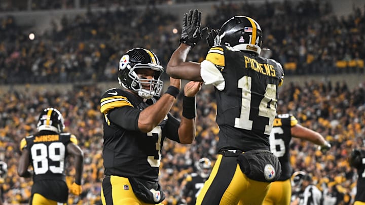Oct 20, 2024; Pittsburgh, Pennsylvania, USA; Pittsburgh Steelers wide receiver George Pickens (14) celebrates an 11 yard touchdown pass with quarterback Russell Wilson (3) iagainst the New York Jets during the second quarter at Acrisure Stadium. Mandatory Credit: Barry Reeger-Imagn Images
