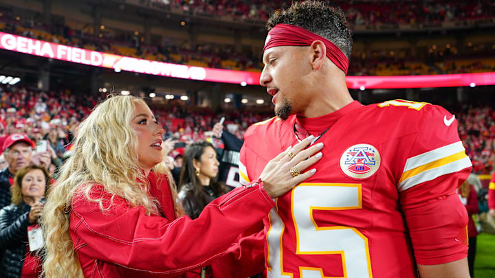 Kansas City Chiefs quarterback Patrick Mahomes (15) greets wife, Brittany Mahomes, during warmups prior to the game against the Washington Commanders at GEHA Field at Arrowhead Stadium.