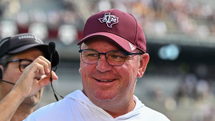 Oct 5, 2024; College Station, Texas, USA; Texas A&M Aggies head coach Mike Elko gets ready for a pre-game interview with the SEC Nation prior to the game against the Missouri Tigers at Kyle Field. Mandatory Credit: Maria Lysaker-Imagn Images. 