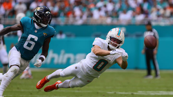 Sep 8, 2024; Miami Gardens, Florida, USA; Miami Dolphins wide receiver Braxton Berrios (0) dives but cannot make a catch against Jacksonville Jaguars safety Darnell Savage (6) during the second quarter at Hard Rock Stadium. Mandatory Credit: Sam Navarro-Imagn Images
