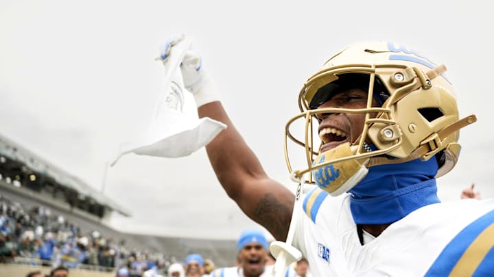 Oct 11, 2025; East Lansing, Michigan, USA; UCLA Bruins defensive back Key Lawrence (4) holds up a towel branding the Michigan State logo after beating the Spartans at Spartan Stadium. Mandatory Credit: Brendan Mullin-Imagn Images