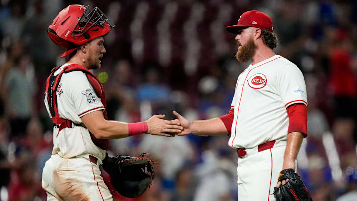 Cincinnati Reds catcher Tyler Stephenson (37) and pitcher Buck Farmer (46) shake hands after the final out of the ninth inning of the MLB National League game between the Cincinnati Reds and the Chicago Cubs at Great American Ball Park in downtown Cincinnati on Monday, July 29, 2024. The Reds won 7-1.