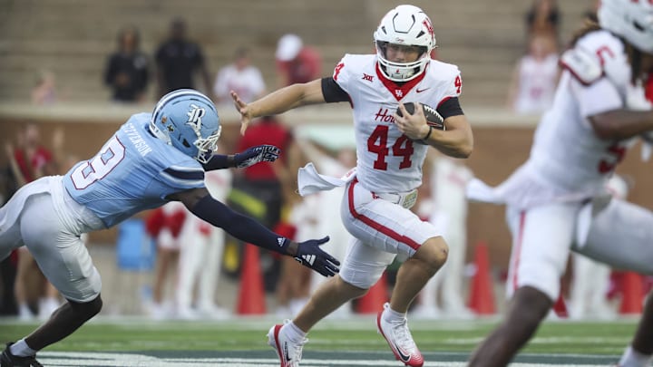 Houston Cougars running back Dean Connors (44) runs with the ball as Rice Owls safety Peyton Stevenson (9) attempts to make a tackle during the first quarter at Rice Stadium. Houston Cougars running back Dean Connors (44) runs with the ball as Rice Owls safety Peyton Stevenson (9) attempts to make a tackle during the first quarter at Rice Stadium.
