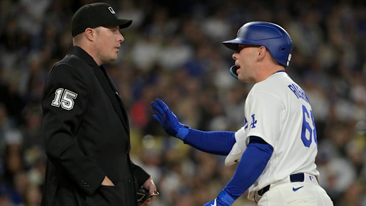 Apr 28, 2026; Los Angeles, California, USA; Los Angeles Dodgers catcher Dalton Rushing (68) argues with home plate umpire umpire Clint Vondrak (15) after he was called for strike 3 on a pitch clock violation -against the Miami Marlins at Dodger Stadium. Mandatory Credit: Jayne Kamin-Oncea-Imagn Images