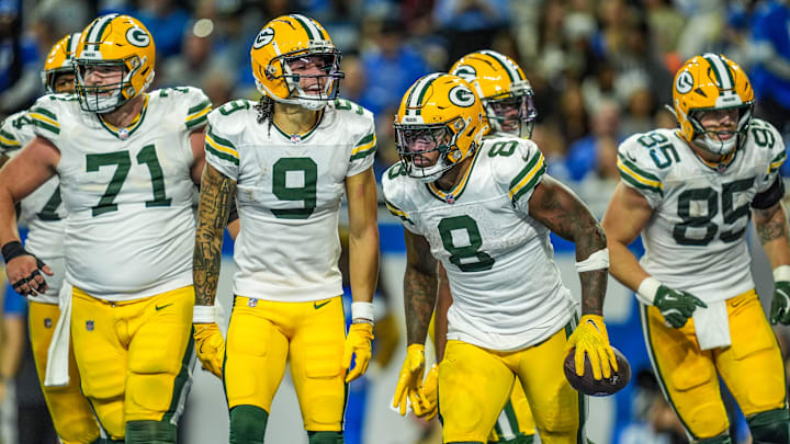 Green Bay Packers running back Josh Jacobs (8) celebrates his touchdown with teammates at Detroit.