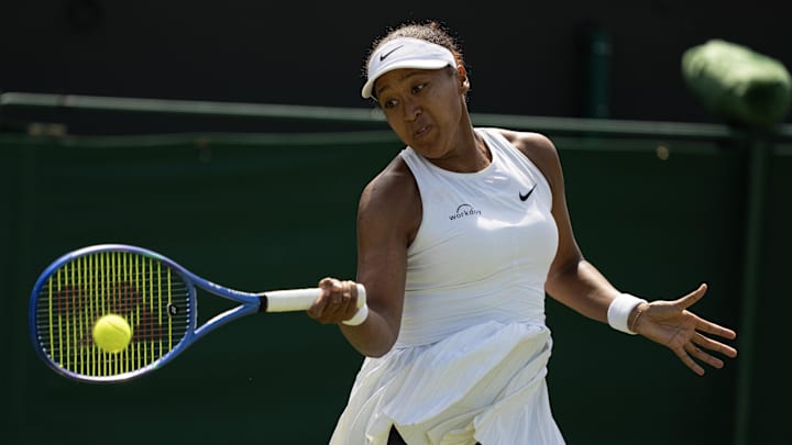 Naomi Osaka of Japan returns a shot during her match against Anastasia Pavlyuchenkova on day five of the 2025 Wimbledon tournament.