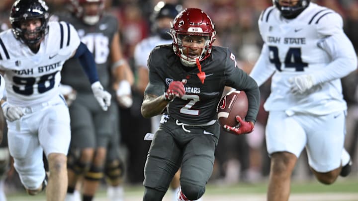 Nov 9, 2024; Pullman, Washington, USA; Washington State Cougars wide receiver Kyle Williams (2) runs the ball in for a touchdown against the Utah State Aggies in the first half at Gesa Field at Martin Stadium.