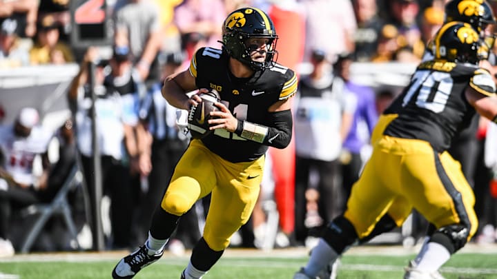 Sep 27, 2025; Iowa City, Iowa, USA; Iowa Hawkeyes quarterback Mark Gronowski (11) rolls out to throw a pass against the Indiana Hoosiers during the first quarter at Kinnick Stadium. Mandatory Credit: Jeffrey Becker-Imagn Images