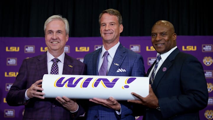 Dec 1, 2025; Baton Rouge, LA, USA; LSU president Wade Rousse, left, LSU new head coach Lane Kiffin and LSU athletic director Verge Ausberry stand together at South Stadium Club at Tiger Stadium. Mandatory Credit: Matthew Hinton-Imagn Images Dec 1, 2025; Baton Rouge, LA, USA; LSU president Wade Rousse, left, LSU new head coach Lane Kiffin and LSU athletic director Verge Ausberry stand together at South Stadium Club at Tiger Stadium. Mandatory Credit: Matthew Hinton-Imagn Images