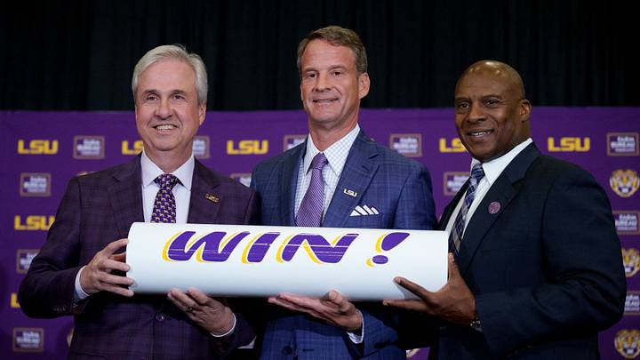 Dec 1, 2025; Baton Rouge, LA, USA; LSU president Wade Rousse, left, LSU new head coach Lane Kiffin and LSU athletic director Verge Ausberry stand together at South Stadium Club at Tiger Stadium. Mandatory Credit: Matthew Hinton-Imagn Images