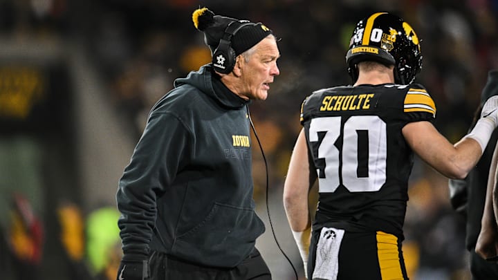 Nov 29, 2024; Iowa City, Iowa, USA; Iowa Hawkeyes head coach Kirk Ferentz reacts as defensive back Quinn Schulte (30) looks on during the first quarter against the Nebraska Cornhuskers at Kinnick Stadium. Mandatory Credit: Jeffrey Becker-Imagn Images Nov 29, 2024; Iowa City, Iowa, USA; Iowa Hawkeyes head coach Kirk Ferentz reacts as defensive back Quinn Schulte (30) looks on during the first quarter against the Nebraska Cornhuskers at Kinnick Stadium. Mandatory Credit: Jeffrey Becker-Imagn Images