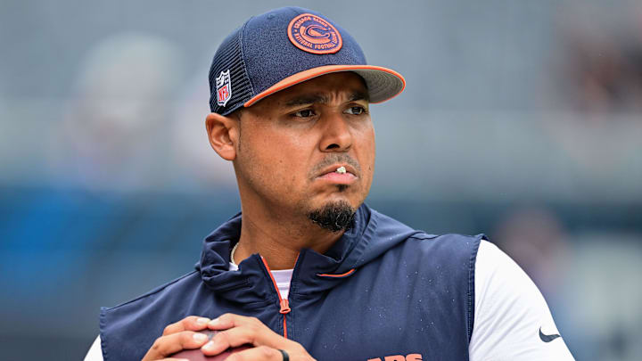 Chicago Bears general manager Ryan Poles plays catch on the sideline