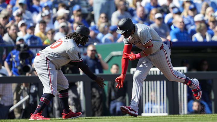 Mar 28, 2024; Kansas City, Missouri, USA; Minnesota Twins third baseman Royce Lewis (23) celebrates with third base coach Tommy Watkins after hitting a home run during the first inning against the Kansas City Royals at Kauffman Stadium. Mandatory Credit: Jay Biggerstaff-USA TODAY Sports