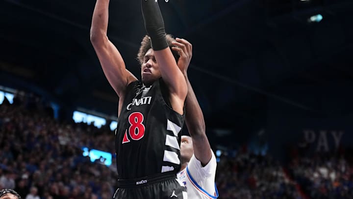 Feb 21, 2026; Lawrence, Kansas, USA; Cincinnati Bearcats forward Baba Miller (18) pulls down a rebound against the Kansas Jayhawks during the second half of the game at Allen Fieldhouse. Mandatory Credit: Denny Medley-Imagn Images