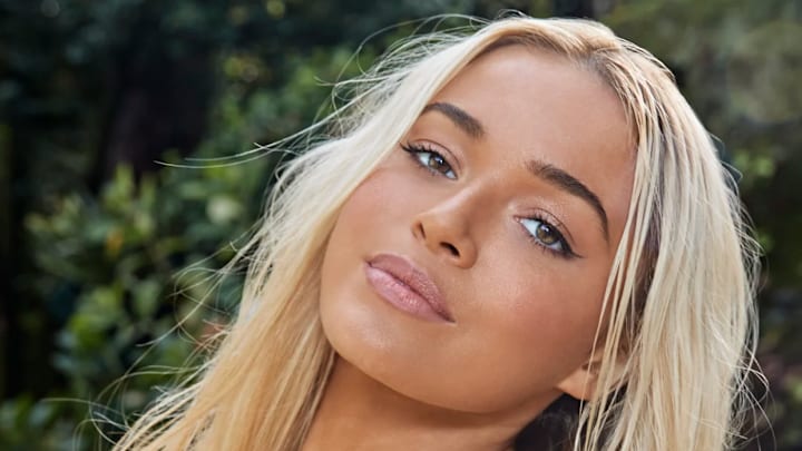 Olivia Dunne was photographed by Ben Watts in Portugal. Swimsuit by Ola Vida. Necklace by Classic Silver, certified as Filigrana de Portugal. 