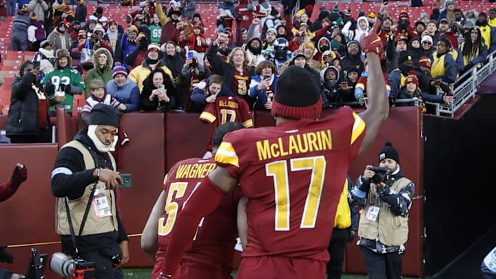Dec 22, 2024; Landover, Maryland, USA; Washington Commanders wide receiver Terry McLaurin (17) celebrates while leaving the field with Commanders linebacker Bobby Wagner (54) after their game against the Philadelphia Eagles at Northwest Stadium. Mandatory Credit: Geoff Burke-Imagn Images