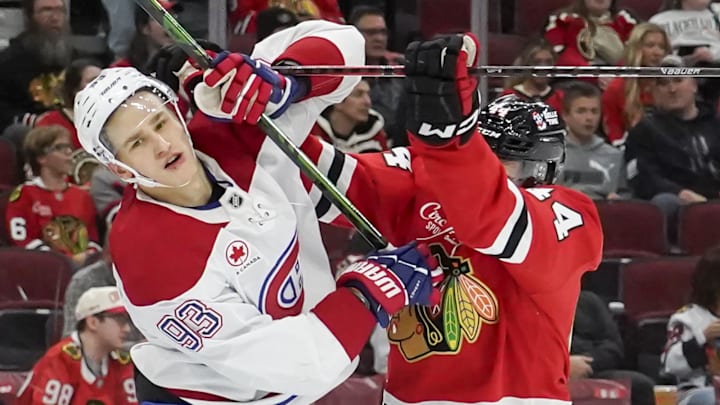 Oct 11, 2025; Chicago, Illinois, USA; Chicago Blackhawks defenseman Wyatt Kaiser (44) checks Montréal Canadiens right wing Ivan Demidov (93) during the second period at United Center. Mandatory Credit: David Banks-Imagn Images