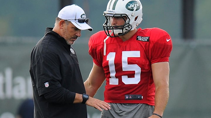 As the Jets quarterbacks coach, Matt Cavanaugh shares some knowledge with quarterback Tim Tebow.
