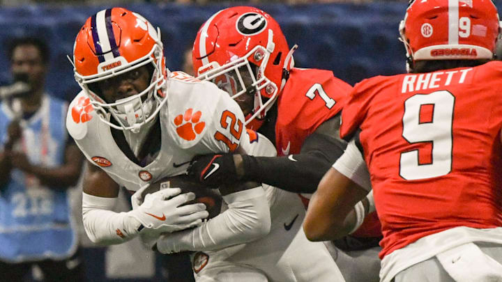 Clemson Tigers wide receiver Bryant Wesco Jr. (12) is tackled by Georgia Bulldogs defensive back Daniel Harris (7) 
