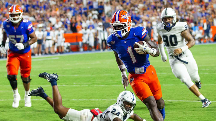 Samford Bulldogs safety Edwin Dearman (24) tries to chase down Florida Gators running back Montrell Johnson Jr. (1) as he scores a touch down during the first half at Ben Hill Griffin Stadium in Gainesville, FL on Saturday, September 7, 2024 against the Samford Bulldogs. The Gators lead 14-0 at the half. [Doug Engle/Gainesville Sun]