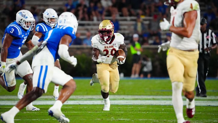 Aug 30, 2024; Durham, North Carolina, USA;  Elon Phoenix running back TJ Thomas Jr. (20) runs with the ball against the Duke Blue Devils during the first half at Wallace Wade Stadium. Mandatory Credit: James Guillory-Imagn Images
