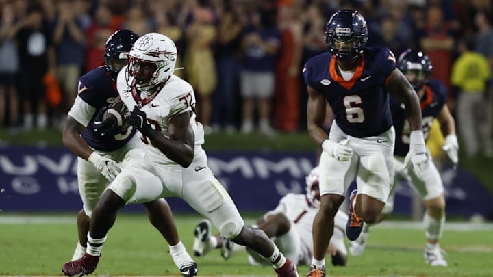 Sep 26, 2025; Charlottesville, Virginia, USA; Florida State Seminoles running back Ousmane Kromah (32) carries the ball past Virginia Cavaliers defensive end Cazeem Moore (6) at Scott Stadium. Mandatory Credit: Geoff Burke-Imagn Images