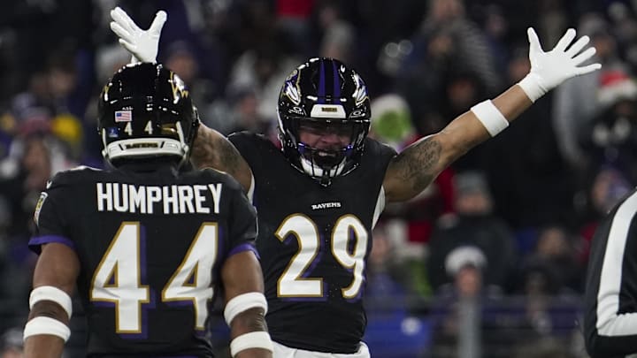Baltimore Ravens safety Ar'Darius Washington celebrates forcing a fumble by New England Patriots quarterback Drake Maye.